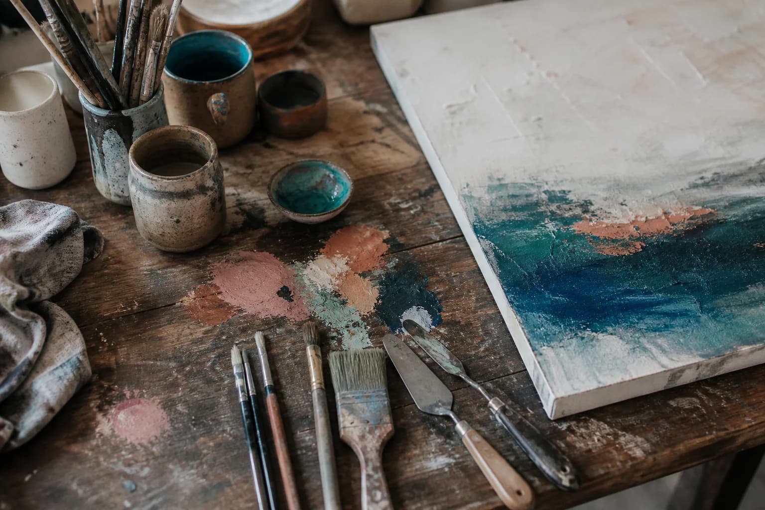 Table de travail, pinceaux et matières